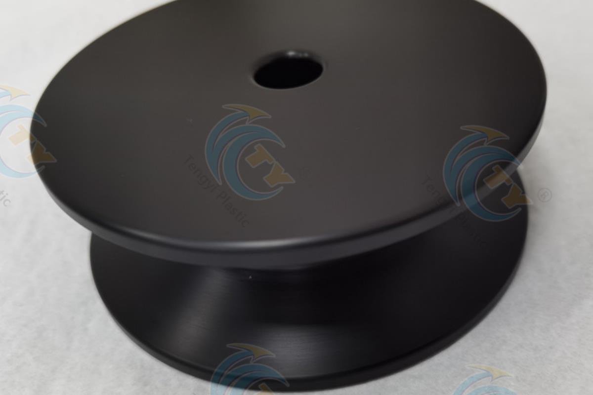 Black anti-static POM sheet formed into a barbell-shaped part